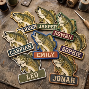 May include: A collection of embroidered fish patches, each featuring a green and cream largemouth bass with an open mouth. Below each fish is a rectangular name tag with the names ARDEN, JASPER, ROWAN, CASPIAN, EMILY, SOPHIE, LEO, and JONAH.