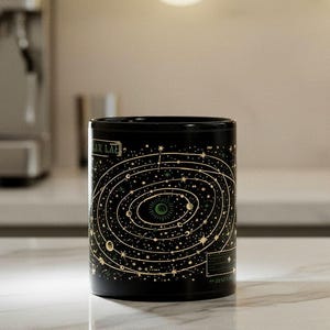 Stellar Lab Astrology Mug – Black ceramic celestial map coffee cup with gold star orbit