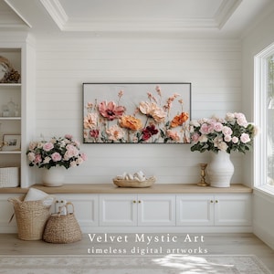 May include: A floral artwork with a black frame, featuring textured flowers in shades of pink, orange, and red. The artwork hangs above a white cabinet with a vase of pink roses. The text "Velvet Mystic Art" is displayed below.