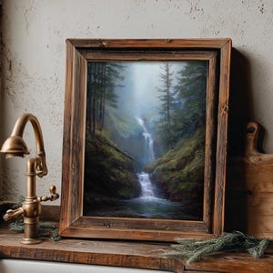 May include: A framed landscape painting of a waterfall cascading through a lush, green forest. The artwork is displayed in a rustic, wooden frame. The text "Velvet Mystic Art, timeless digital artworks" is visible at the bottom.