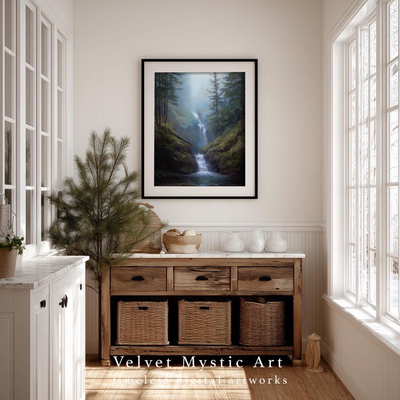 May include: A framed landscape art print depicting a waterfall cascading through a lush green forest. The artwork is displayed above a rustic wooden console with woven baskets and drawers. The text "Velvet Mystic Art" is visible at the bottom.