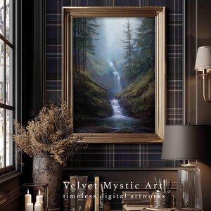 May include: A framed landscape painting of a waterfall cascading through a forest, with a gold-colored frame. The painting is displayed on a wall with a plaid pattern. The text "Velvet Mystic Art timeless digital artworks" is at the bottom.