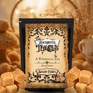 May include: A black pouch with a vintage-style label reading "The Enchanted Tea Cup" and "Sugar Cubes." The label is brown with ornate black scrollwork. Several brown sugar cubes are in the foreground.