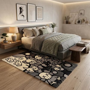 May include: A rectangular area rug featuring a repeating graphic pattern of cartoon-style characters with X-shaped eyes and gloved hands. The design uses a color palette of cream, light gray, dark gray, and black, covering the entire surface.