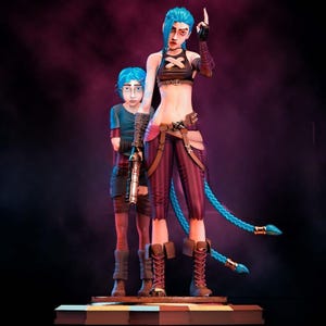 May include: A detailed figurine of two characters with blue hair. The taller figure wears a black crop top, striped pants, and boots, with a finger raised. The other figure wears a blue shirt and holds a gun. The figures stand on a checkered base.