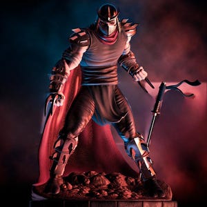 May include: A detailed figurine of Shredder from Teenage Mutant Ninja Turtles. The figure is in a dynamic pose, wearing a helmet, armor, and a red cape. He holds a katana and has claw-like weapons on his hands. The figure stands on a rocky base.