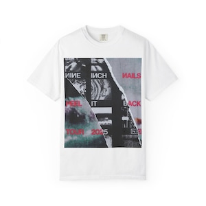 May include: White t-shirt with a graphic design featuring the words "NINE INCH NAILS" and "PEEL IT BACK TOUR 2025". The design has a torn paper aesthetic with black, white, red, and grey elements.