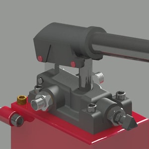 May include: A detailed rendering of a mechanical device. The design features a red base, a gray body with various components, and a black handle. Metallic accents and fasteners are visible throughout the assembly.