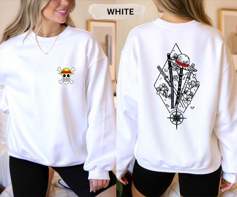 May include: White sweatshirt with a small skull and crossbones graphic on the front and a larger graphic on the back featuring a straw hat, swords, and flowers. The word "WHITE" is above the sweatshirt.