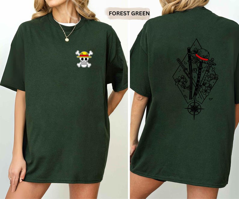 May include: Forest green t-shirt with a small skull and crossbones graphic on the front. The back of the shirt features a black graphic design with a hat, swords, and a compass rose. The shirt is a relaxed fit.