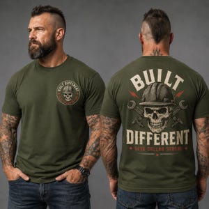 May include: An olive green t-shirt featuring a small circular graphic on the front chest with a skull wearing a hard hat and the text "BUILT DIFFERENT BLUE COLLAR STRONG". The back displays a large graphic of a skull in a hard hat with crossed wrenches and the text "BUILT DIFFERENT BLUE COLLAR STRONG".