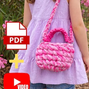 May include: A pink and white crocheted handbag with a braided strap and handle. The bag is worn over the shoulder. The image also includes a PDF icon and a YouTube video icon.