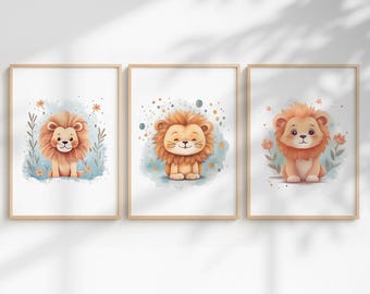 May include: Three framed watercolor prints featuring adorable cartoon lions. Each lion has a fluffy orange mane and is set against a soft, colorful background with floral and abstract elements. The frames are a light wood color.