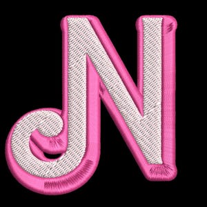 May include: Pink felt letter N with white stitching. The letter is outlined in pink and has a white interior.