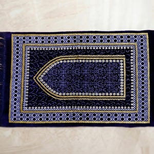 handwoven turkish prayer rug, seccade islamic prayer mat, velvet texture rug, floral border prayer rug, soft salah mat, muslim home decor rug, prayer room accessory, ramadan kareem gift, eid mubarak present, hajj umrah gift, portable travel prayer mat, compact lightweight mat, traditional turkish pattern, ethnic motif carpet, sajjadah worship mat, comfortable kneeling pad, prayer corner essentials, qibla corner decor, woven cotton blend,