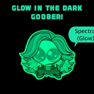Op de afbeelding: Een glow-in-the-dark sticker met een gestileerd personage met grote ogen en golvend haar. De tekst GLOW IN THE DARK GOOBER! staat erboven en een tekstballon aan de rechterkant bevat de tekst Spectra! (Glow). Het ontwerp is felgroen.