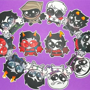May include: A collection of eleven individual die-cut stickers featuring stylized cartoon characters with large eyes, various hair colors, and distinct outfits, arranged in a circular pattern against a solid purple background.