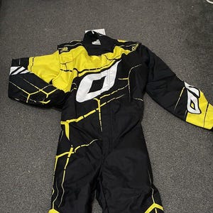 Pu&ograve; includere: Tuta da corsa nera e gialla con dettagli bianchi. La tuta presenta un design geometrico e il nome del marchio "OMP" in bianco. Ha maniche lunghe e una cerniera a tutta lunghezza. Realizzata in materiale resistente.