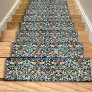 May include: Stair treads with a repeating floral and bird pattern in shades of blue, green, red, and yellow. The treads are installed on wooden stairs, creating a decorative and functional element for home decor.