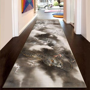 May include: A long, rectangular rug with a detailed dragon illustration in grey and white tones. The dragon is set against swirling clouds, creating a dramatic design. The rug is placed in a hallway, adding a touch of art.