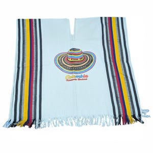 May include: Light blue poncho with a colorful hat graphic and the word "Colombia". The poncho has vertical stripes in yellow, red, blue, and black. The bottom edge has a fringe.