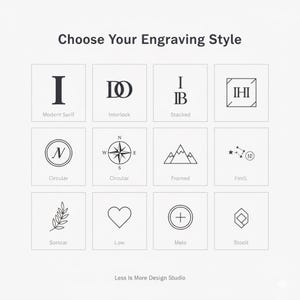 May include: A grid of twelve black and white engraving style options labeled Choose Your Engraving Style. Designs include letters, a compass, mountains, stars, a leaf, a heart, and geometric shapes. Less Is More Design Studio is at the bottom.