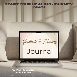 Puede incluir: Un portátil que muestra un diario titulado "Gratitude & Healing Journal" con el texto "Start Your Healing Journey Today". El diario está diseñado para iPad, Goodnotes y formatos PDF imprimibles. El portátil está sobre un sofá de tonos neutros.