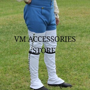 May include: Blue and white historical costume pants with gold buttons and the text "VM ACCESSORIES STORE". The pants have a high waist and are paired with white spats that button up the side. The spats cover the lower legs and feet.