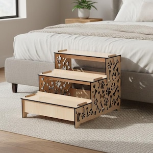 May include: A three-step wooden pet step stool with paw and bone cutouts. The light-colored wood pet steps are designed to help small dogs or cats reach a bed. The step stool is 20 inches long, 18 inches wide, and 16 inches high.