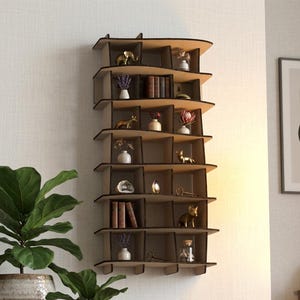 May include: A wall-mounted wooden shelving unit with a wavy, organic silhouette featuring multiple vertical and horizontal compartments. The shelves are filled with small decorative items including miniature figurines, vases, books, and crystals.