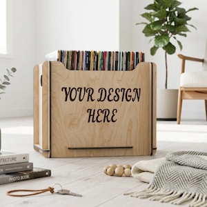 May include: A wooden record storage crate with the text "YOUR DESIGN HERE" in brown. The crate is filled with vinyl records. The crate is sitting on a light wood floor.