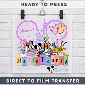May include: A colorful graphic featuring Disney characters, including Mickey and Minnie Mouse, Goofy, Donald Duck, and Pluto. The design includes the text "Hello Fourty" and "Est.1986", with a castle and balloons. The words "Ready to Press" and "Direct to Film Transfer" are also visible.