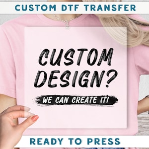 The image is a promotional poster for a custom DTF (Digital Transfer Factory) service, featuring a person wearing a pink shirt and holding a white sign with the text "CUSTOM DESIGN? WE CAN CREATE IT!"