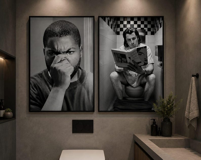 May include: Two framed black and white wall art prints displayed side by side. The left print shows a close-up of a person covering their nose with their hand. The right print depicts a person sitting on a toilet reading a book in a tiled room.