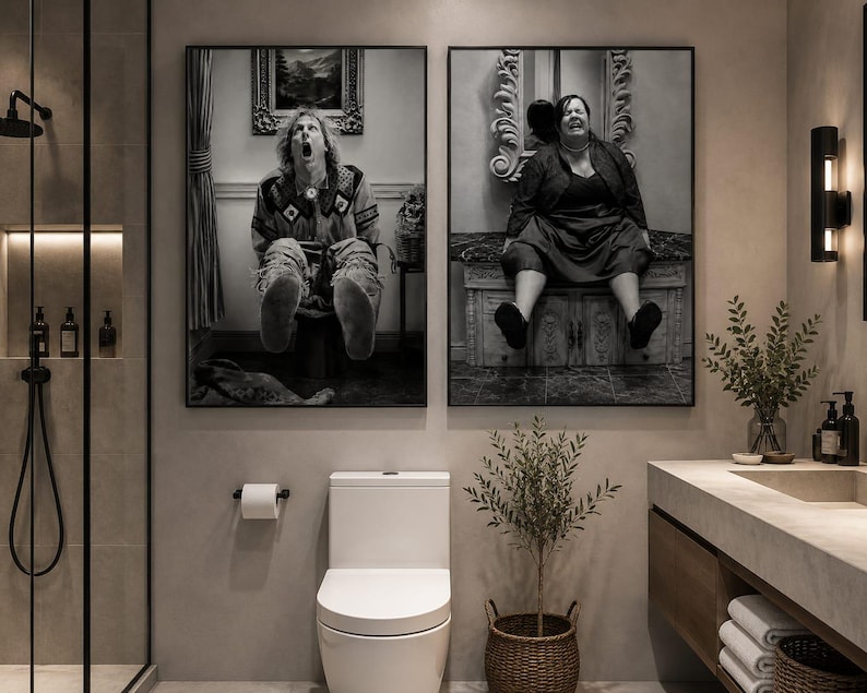 May include: Two rectangular black and white wall art prints displayed side by side in a bathroom. The left print shows a person with long hair sitting on a toilet with their mouth open. The right print shows a person sitting on a decorative vanity.