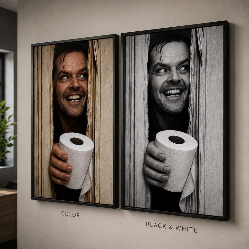 May include: Two framed wall art prints featuring a man peering through a broken wooden door while holding a roll of toilet paper. One print is in sepia tones labelled COLOR, and the other is in monochrome labelled BLACK & WHITE, both in black frames.