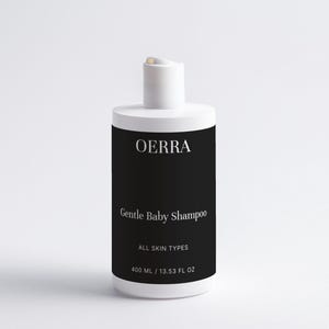 May include: White bottle of OERRA Gentle Baby Shampoo with a black label. The label includes the text "ALL SKIN TYPES" and "400 ML / 13.53 FL OZ". The bottle has a white flip-top cap.