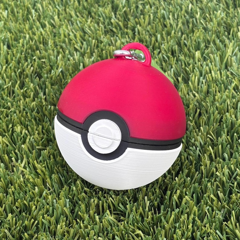 pokemon pokeball dog bag holder in the grass
