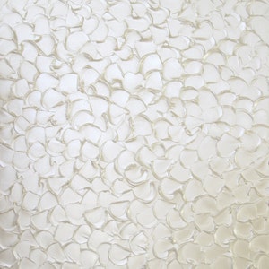 May include: White abstract painting with a textured, raised surface. The paint is applied in a swirling, circular pattern, creating a sense of movement and depth.