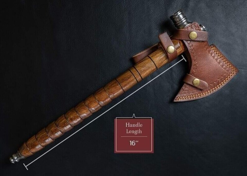 May include: A handcrafted axe with a wooden handle and a brown leather sheath. The handle is 40.6 cm long. The axe head is made of metal and has a sharp edge. The leather sheath is secured with brass-colored rivets.