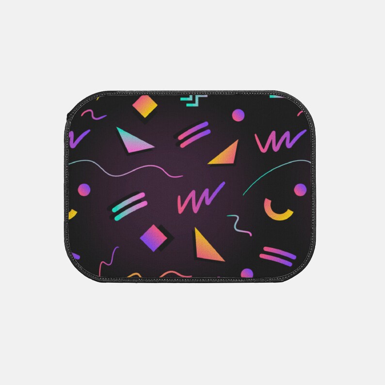 May include: A black mousepad with a geometric pattern in shades of pink, purple, yellow, and blue. The pattern includes triangles, squares, and wavy lines.