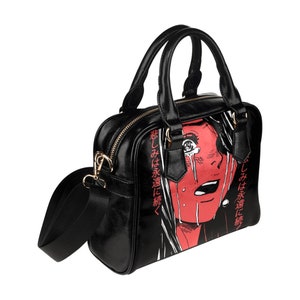 May include: Black handbag with a red and white graphic of a crying face. The bag has a top handle and a detachable shoulder strap. The text "悲しみは永遠に続く" is printed in red on the side of the bag.
