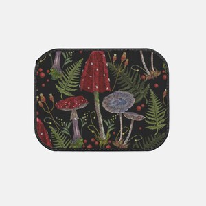 May include: Embroidered black fabric with a repeating pattern of red and white mushrooms, blue mushrooms, and green ferns.