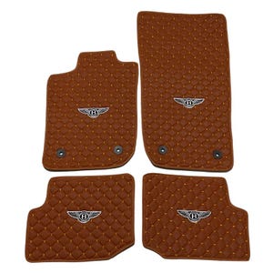 May include: Set of four brown car floor mats with a diamond-stitched pattern and the Bentley logo. The mats are designed to fit the driver's side, passenger side, and rear footwells. The mats have a luxurious appearance.