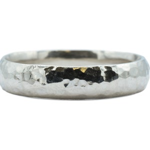 May include: A silver hammered wedding band.