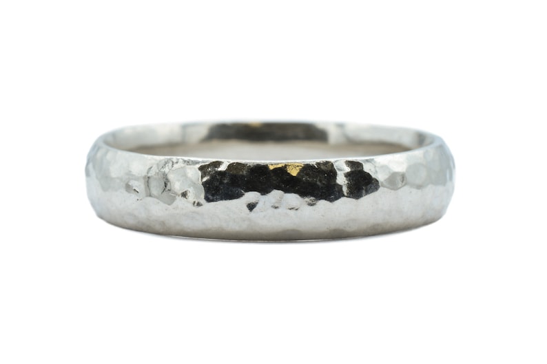 May include: A silver hammered wedding band.