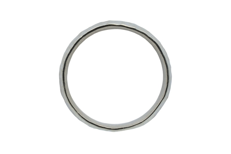 May include: A silver band ring with a hammered texture.