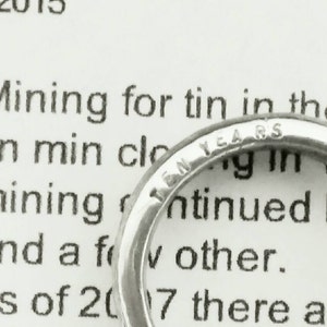 May include: A silver ring with the inscription "Ten Years" on the band.