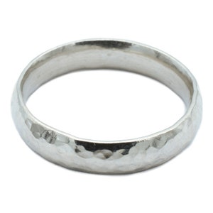 May include: A silver hammered wedding band.