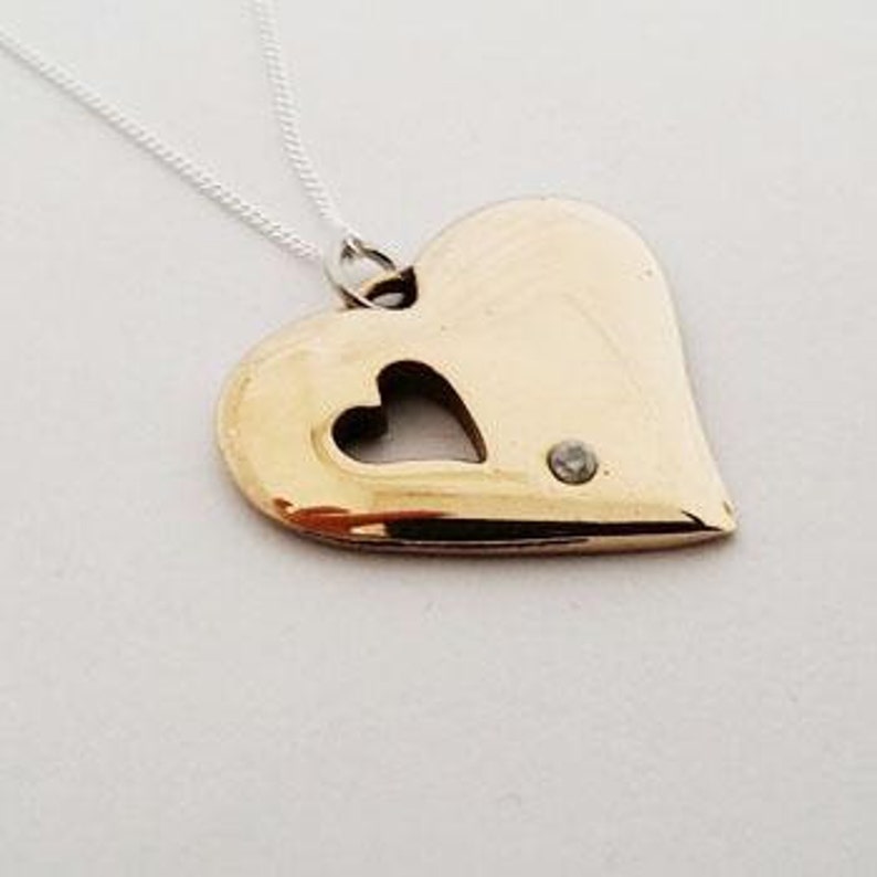 a bronze heart necklace with a diamond
